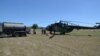 Хеликоптерите полнат гориво од импровизиран хелиодром во близина на пожарите