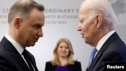 Poland's President Andrzej Duda (left) greets U.S. President Joe Biden next to Slovakia's then-President Zuzana Caputova in Warsaw in February 2023.