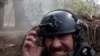 RFE/RL correspondent Maryan Kushnir reacts as Ukrainian forces fire artillery toward Russian positions near Kupyansk in the Kharkiv region. 