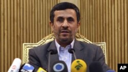 Iran President Mahmud Ahmadinejad briefed the media before departing Tehran's airport for Tajikistan on September 4.