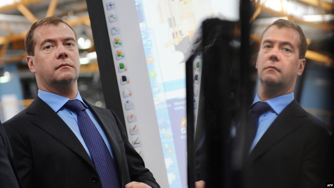 Russian President Dmitry Medvedev adjusts his jacket during a visit to Russian IT-manufacturing company Kraftway, in Obninsk, in April 2010.