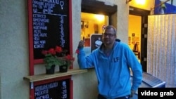 Oleksiy Pobihay stands outside the shop where he sold coffee and other refreshments from his home.