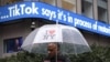 A man walks past an information display in New York City following TikTok's announcement on January 19 that it was restoring its service in the United States. 