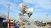 Smoke billows from the scene of a suicide bomb blast that targeted a police headquarters in Kunduz, on February 10.