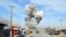 Smoke billows from the scene of a suicide bomb blast that targeted a police headquarters in Kunduz, on February 10.