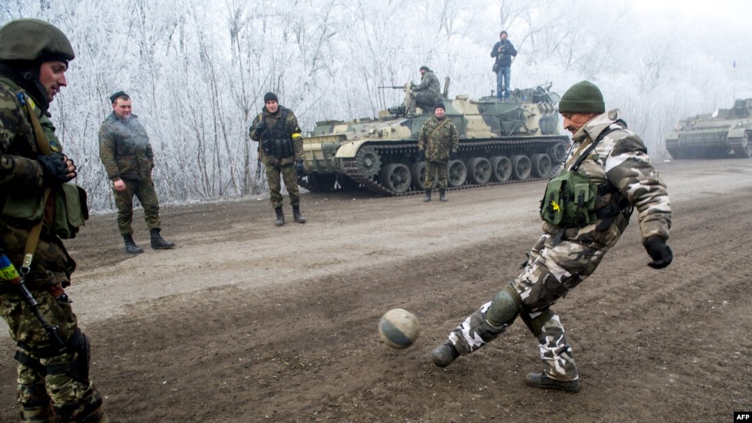 Ukrainian servicemen play football on a road at Svitlodarsk, approaching Debaltseve on February 15, hours after a cease-fire came into effect. The truce seems to have been cautiously observed by both sides, despite accusations by Kyiv and Washington that Russia had fueled a final push by rebels to gain territory before the start of the cease-fire.