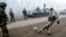 Ukrainian servicemen play football on a road at Svitlodarsk, approaching Debaltseve on February 15, hours after a cease-fire came into effect. The truce seems to have been cautiously observed by both sides, despite accusations by Kyiv and Washington that Russia had fueled a final push by rebels to gain territory before the start of the cease-fire.