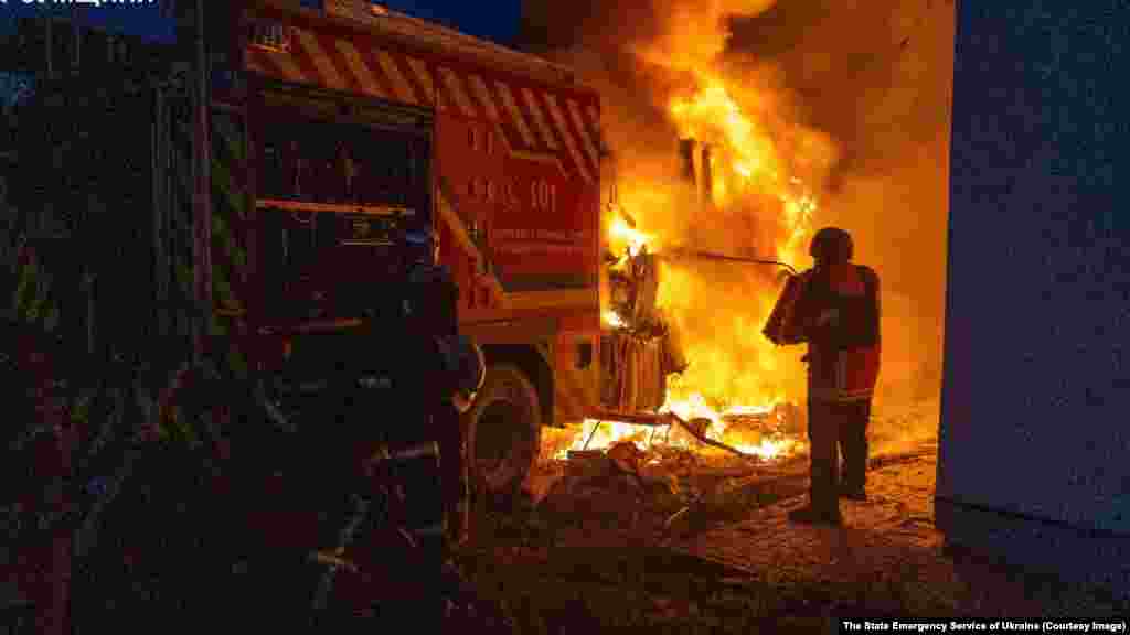 A Ukrainian firefighter attempts to extinguish a blaze that destroyed a fire truck on November 24.Ukraine's State Emergency Service claimed the vehicle was struck by a Russian drone as firefighters were responding to the aftermath of a strike on the northeastern city of Sumy.