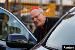 Cardinal Peter Erdo reacts as he enters a vehicle at the Vatican on April 22.