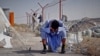 An Afghan man sits at the border between Afghanistan and the southeastern Iranian province of Sistan-Baluchestan.