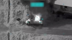 Smoke rises from a vehicle following a US strike in Iran.