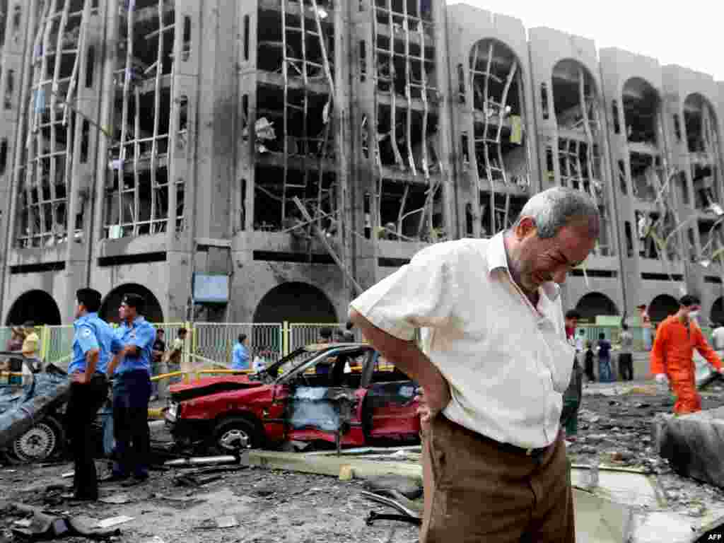 An Iraqi man weeps after twin car bombings at the Justice and Labor ministries in Baghdad on October 25 killed at least 90 people.