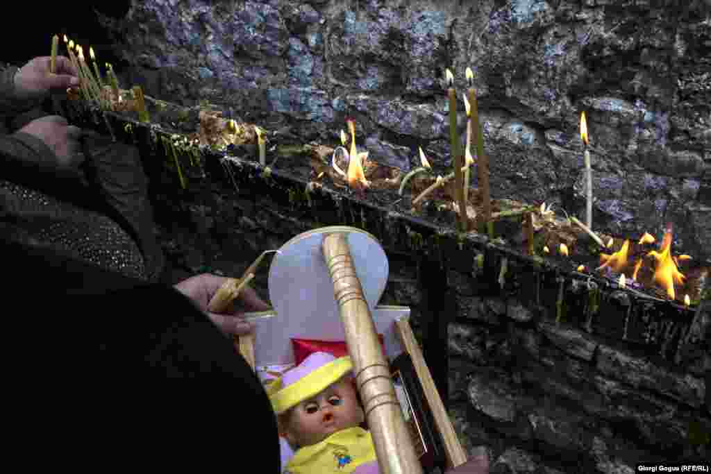 Before the priest&#39;s blessing, participants light candles and circle the church three times -- another part of the ritual.