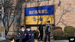 A sign outside the Canadian Embassy in Beijing showing the Ukraine flag on March 3 reads, "We stand together with Ukraine."