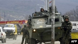 Spanish KFOR soldiers secure a bridge in Mitrovica