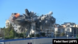 A ball of fire rises from the site of an Israeli strike that targeted a building near Beirut's international airport on March 31.