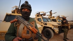 Members of the Popular Mobilization Forces stand guard at a military base near the Iraqi-Syrian border in Al-Qaim. (file photo)