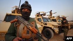 Members of the Popular Mobilization Forces stand guard at a military base near the Iraqi-Syrian border in Al-Qaim. (file photo)