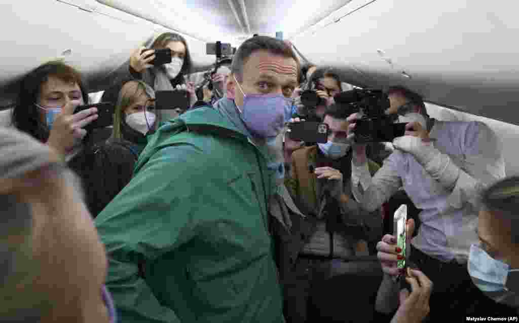 Navalny is surrounded by journalists inside the plane in Berlin prior to his flight to Moscow on January 17, 2021. After recovering from his poisoning, Navalny decided to return to Russia. Upon arrival in Moscow, he was detained on charges of violating the terms of his probation by leaving the country without permission.