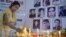An Indian journalist lights candles during a vigil for Afghan journalists who were killed in a targeted suicide bombing in April, including two reporters who worked for RFE/RL's Radio Free Aghanistan, as well as a female trainee.