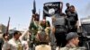 Iraqi security forces pull down a flag belonging to Sunni militant group Islamic State of Iraq and the Levant (ISIL) during a patrol in the town of Dalli Abbas in Diyala Province on June 30.