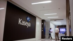 Staff enter the headquarters of information technology firm Kaseya in Miami