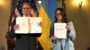 U.S. Treasury Secretary Scott Bessent (left) and Ukrainian First Deputy Prime Minister Svyrydenko pose for photographers, showing the minerals deal they signed in Washington on April 30. 