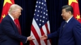 US President Donald Trump and Chinese leader Xi Jinping greet each other as they arrive for talks in Busan on October 30.