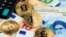 Bitcoin coins pictured with euros and Iranian rials (illustrative photo)