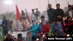 Maryam Nawaz Sharif, center, in blue dress, a leader of the Pakistan Democratic Movement, waves to her supporter during an anti-government rally in Multan, Punjab, on November 30.