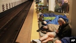 Ukrainians take shelter in a Kyiv subway station after Russia launched a massive missile-and-drone assault on the country overnight on April 24.
