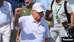 US President Donald Trump walks out of the clubhouse during a golf tournament at his National Bedminster club in New Jersey on August 9.