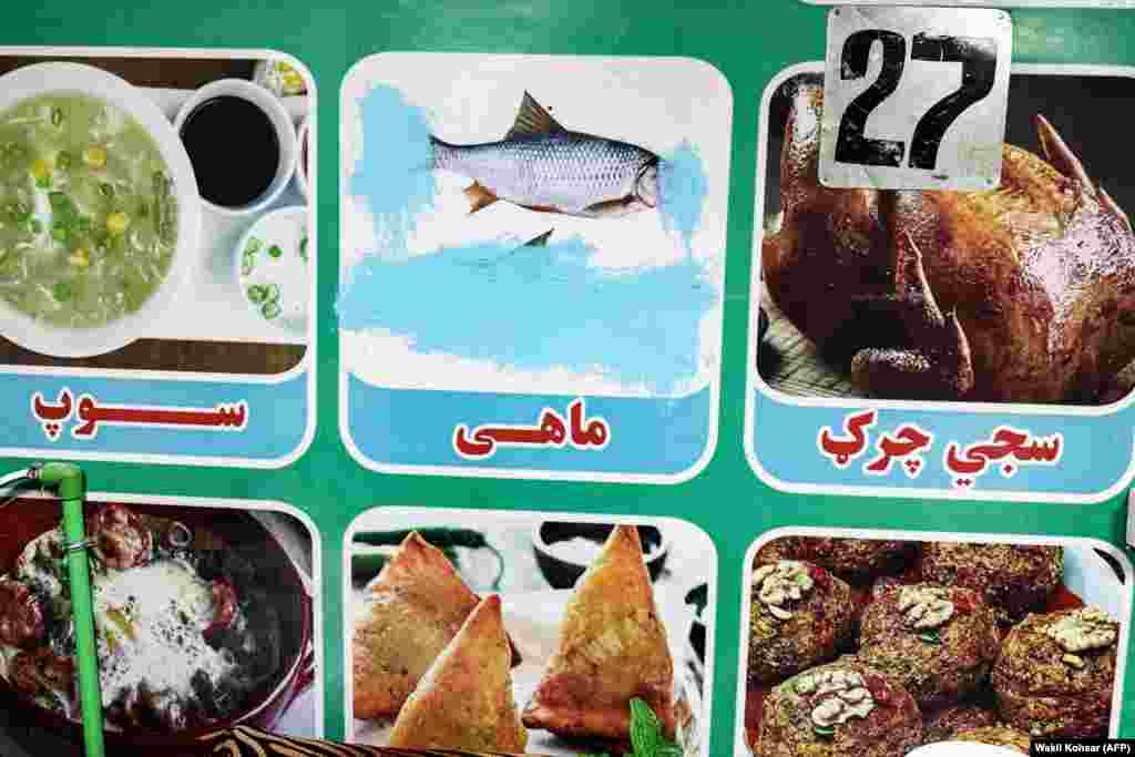 A food menu in the southern Helmand Province showing what an AFP photographer describes as “censored” fish.On January 8, the Afghanistan Journalists Center announced the Taliban had begun enforcing the ban in the central Uruzgan Province, making it the 24th of Afghanistan’s 34 provinces where a law forbidding images of living things is currently in force.