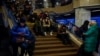 People take shelter inside a metro station during a Russian military strike on Kyiv on December 13. 