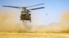 A US Army handout photo released on July 15 shows three Chinook helicopters preparing to land in the Middle East during routine flight operations.