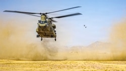 A US Army handout photo released on July 15 shows three Chinook helicopters preparing to land in the Middle East during routine flight operations.