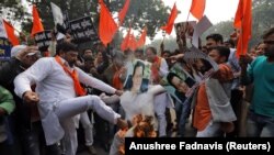 Activists from a right-wing Hindu group burn an effigy of Pakistani Prime Minister Imran Khan at a protest against a bus attack that killed 44 police in south Kashmir on February 14.