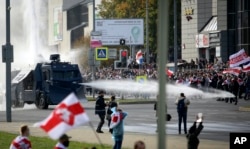 Belarusian police use a water cannon against demonstrators during a rally in Minsk on October 4, 2020.