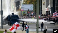 Police use a water cannon agains demonstrators at a rally in Minsk following a presidential election in August 2020 that handed Alyaksandr Lukashenka victory despite claims by opposition leaders that the vote was rigged.