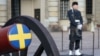 A Swedish soldier stands guard next to a ceremonial cannon in the courtyard of the Royal Palace in Stockholm on February 25.