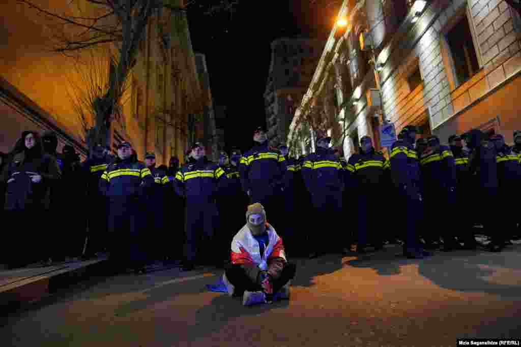 A demonstrator in Tbilisi holds a sit-down protest in the Georgian capital against the results of controversial parliamentary elections last month.&nbsp;