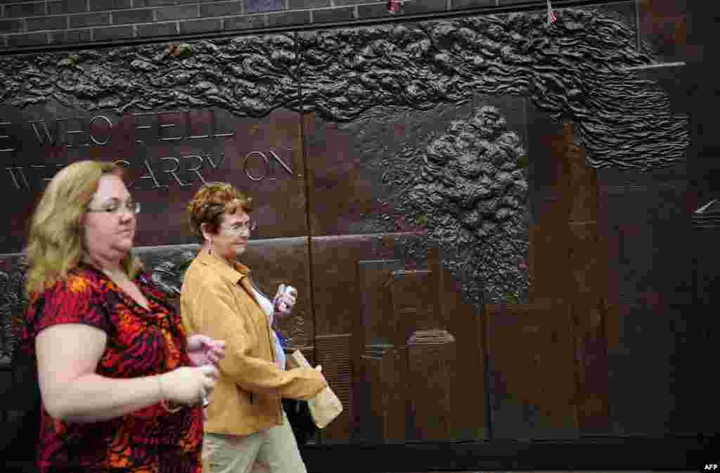 The reflecting pools are just two of many memorials around Ground Zero. On one of the new buildings of the World Trade Center complex, plaques commemorate the firefighters who died during the rescue efforts.