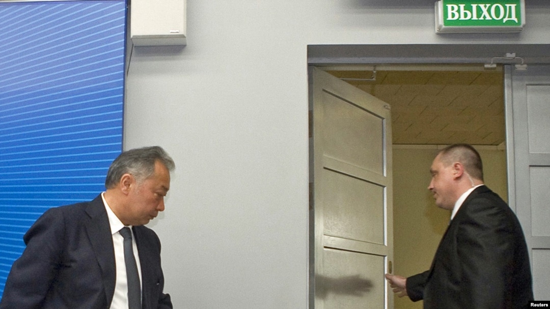 Deposed Kyrgyz President Kurmanbek Bakiev (left) leaves a news conference in the Belarusian capital, Minsk, on April 23.