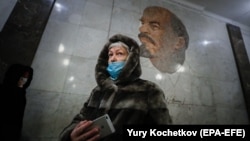 An elderly woman wearing a face mask to protect against the coronavirus walks in Moscow's Metro earlier this week.