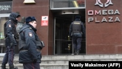 Russian police officers gather at the entrance to a business center that houses an FBK office in Moscow during a previous round of searches.