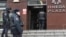 Russian police officers gather at the entrance to a business center that houses an FBK office in Moscow during a previous round of searches.
