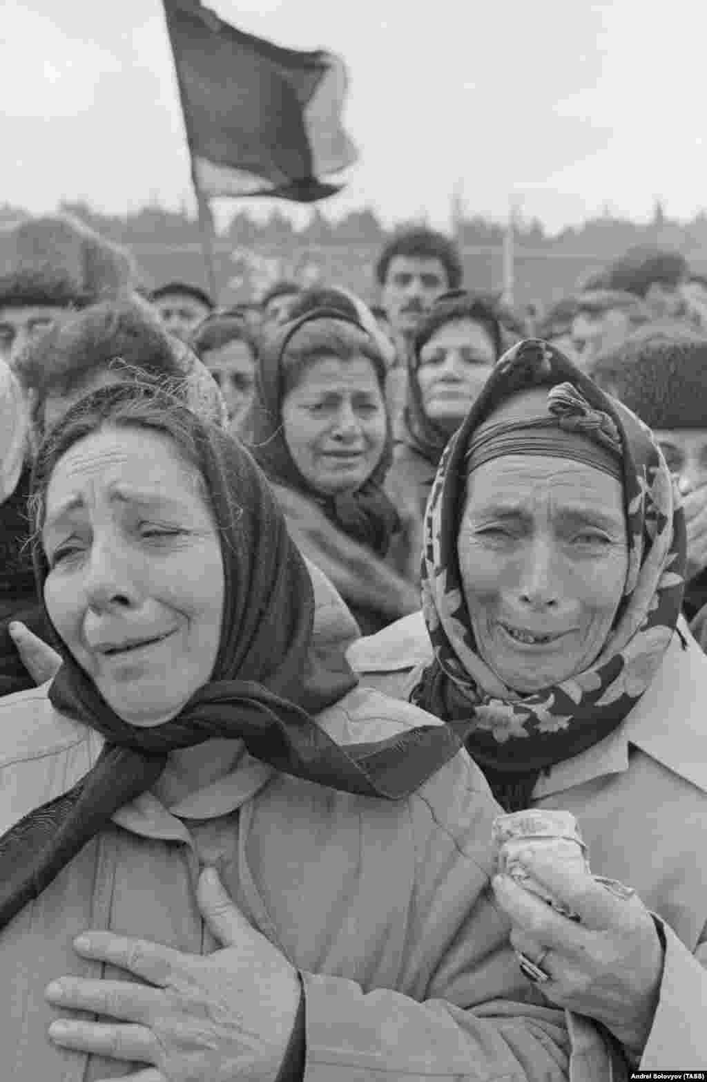 Relatives mourn the victims of the bloody crackdown at a funeral in Baku on January 21.