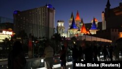 U.S. - People stand along a pedestrian walkway looking towards where a mass shooing at the Route 91 Harvest Country Music Festival took place last night on the Las Vegas Strip in Las Vegas, Nevada, U.S., October 2, 2017.