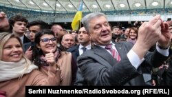 Ukrainian President Petro Poroshenko takes selfies with supporters at Olimpiyskyi Stadium in Kyiv on April 14.