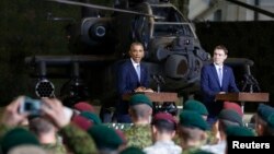 U.S. President Barack Obama (left) and Estonian Prime Minister Taavi Roivas speak to U.S. and Estonian troops at Tallinn Airport on September 3.